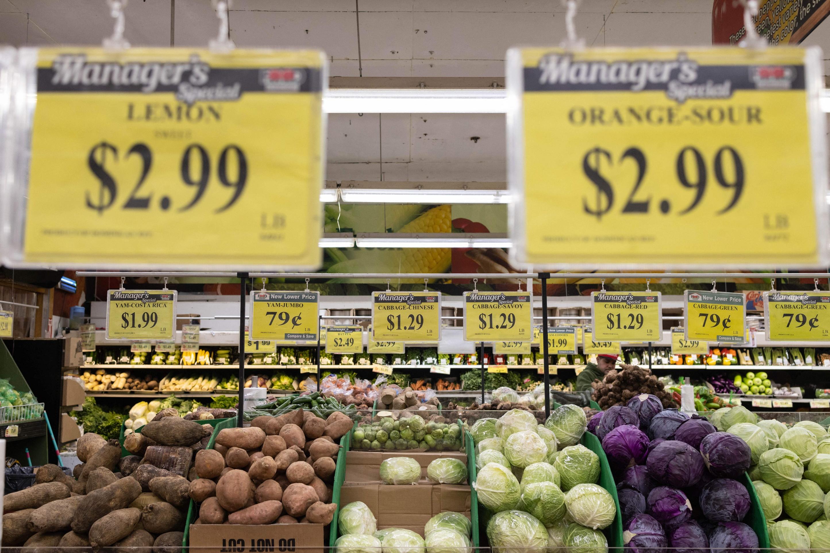 Price tags are displayed for produce at a grocery store supermarket.