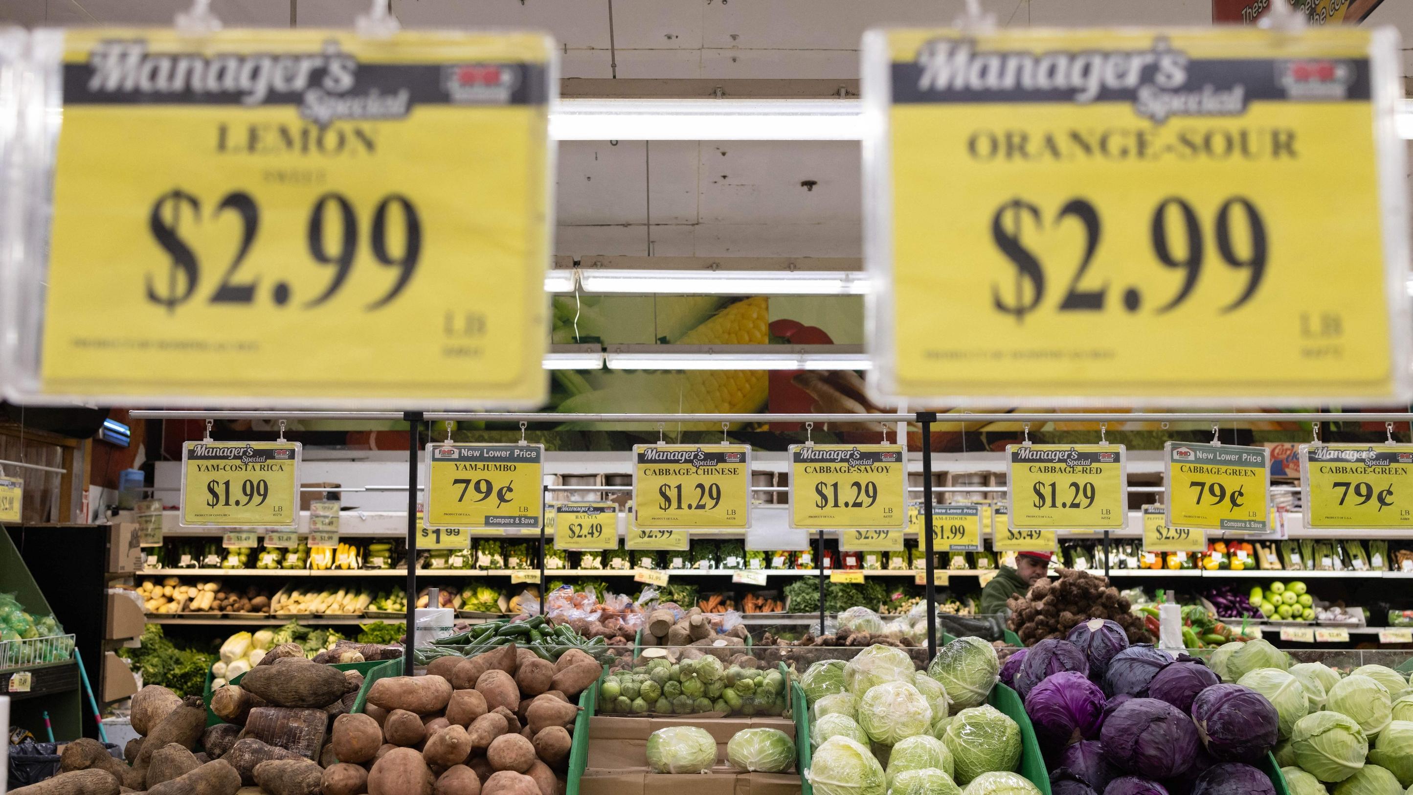 Price tags are displayed for produce at a grocery store supermarket.