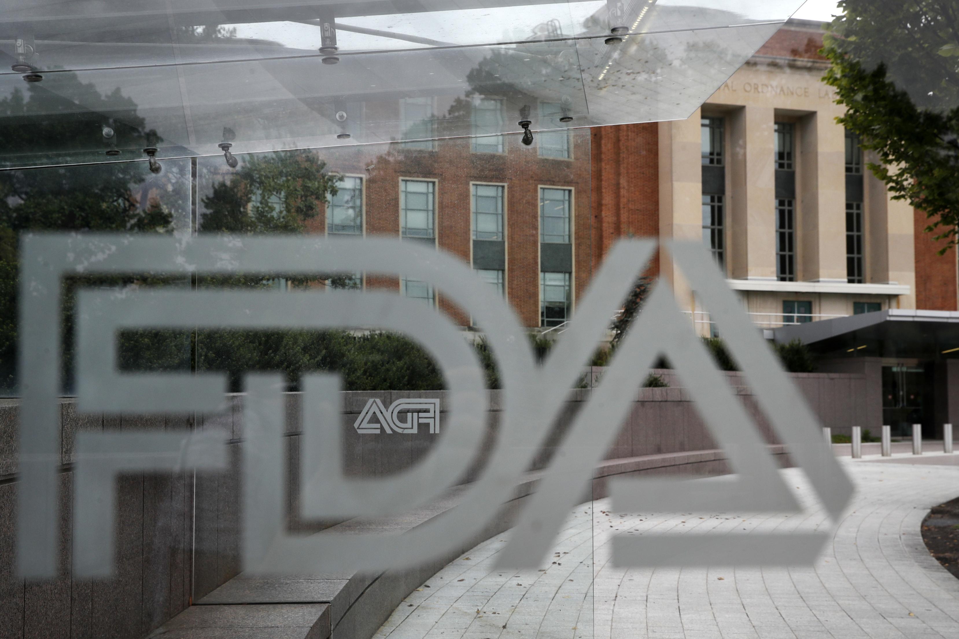 A file photo of the FDA logo on a window overlooking an office building.