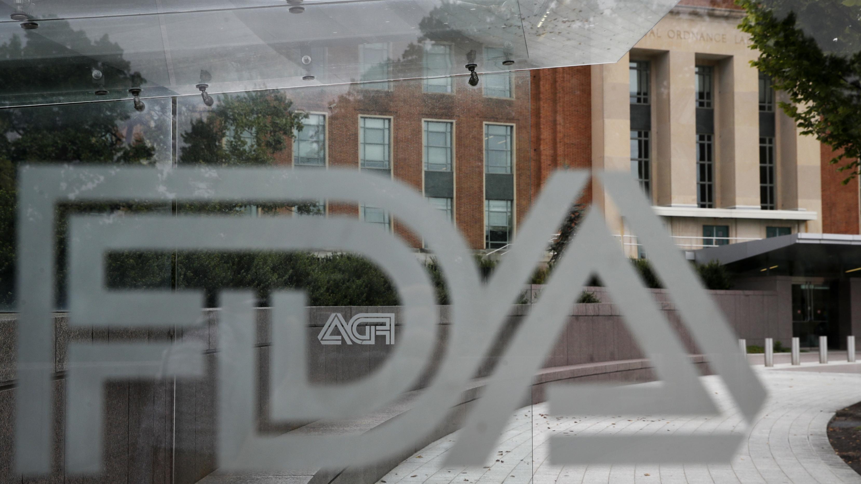 A file photo of the FDA logo on a window overlooking an office building.