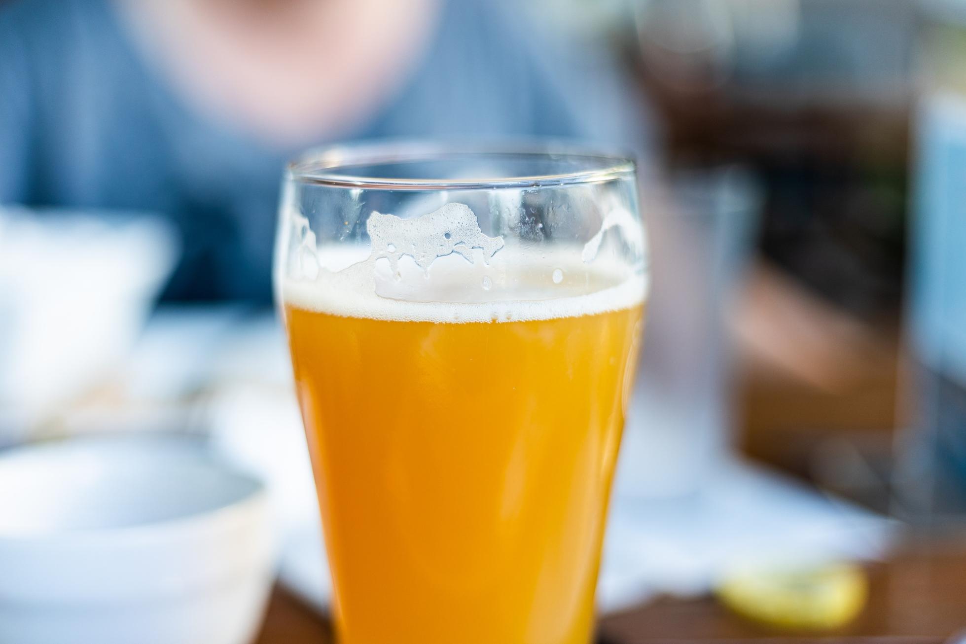close up of a glass of hazy IPA beer