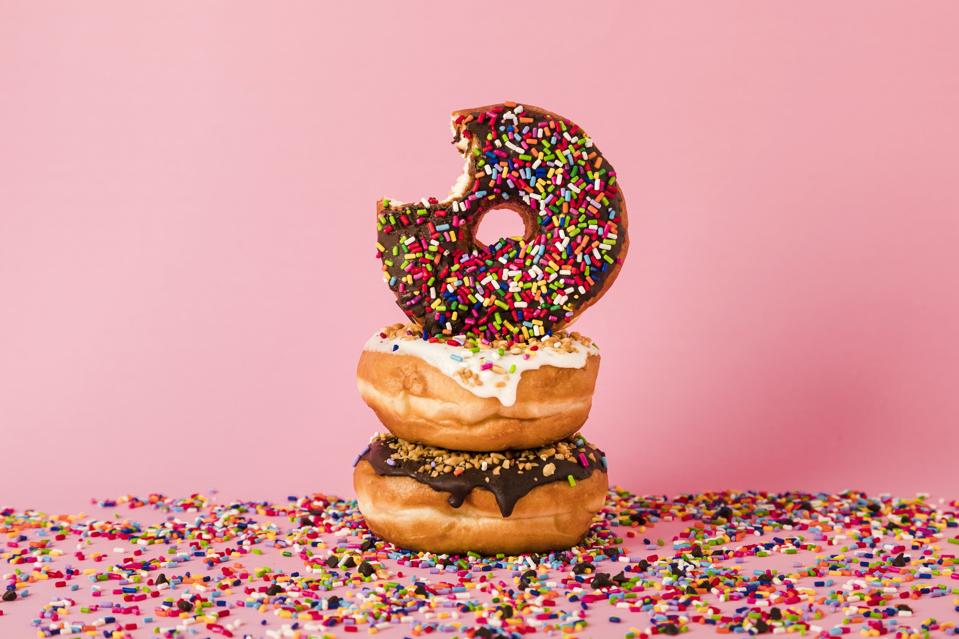 Three donuts, one with bite