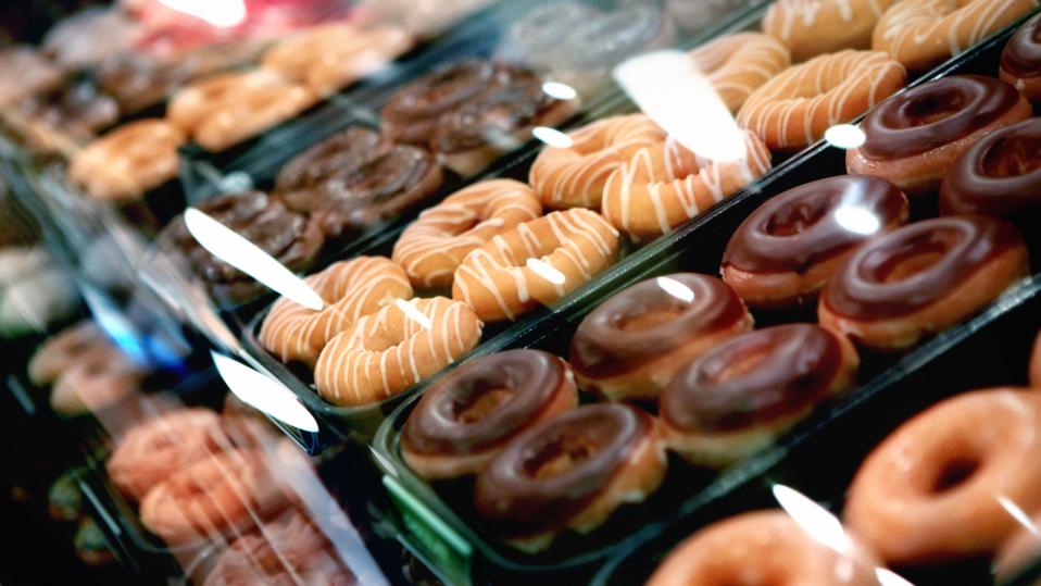 Variety of donuts on a tray in a display case