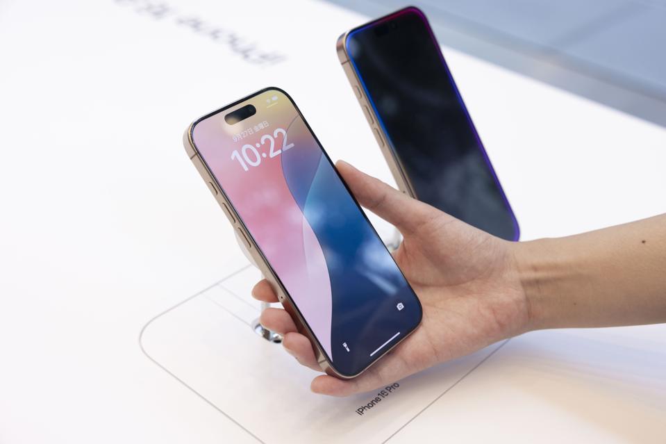 A customer holds the new Apple iPhone 16 Pro in her hand...