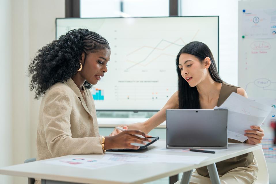 Following a successful business meeting, the two professionals engage in a casual conversation.