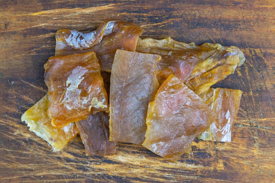 Dried catfish fillet on wooden background. Snack on fish with beer. Close-up