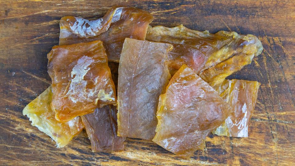 Dried catfish fillet on wooden background. Snack on fish with beer. Close-up