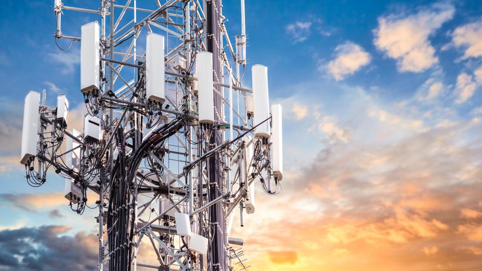 5G Sunset Cell Tower: Cellular communications tower for mobile phone and video data transmission
