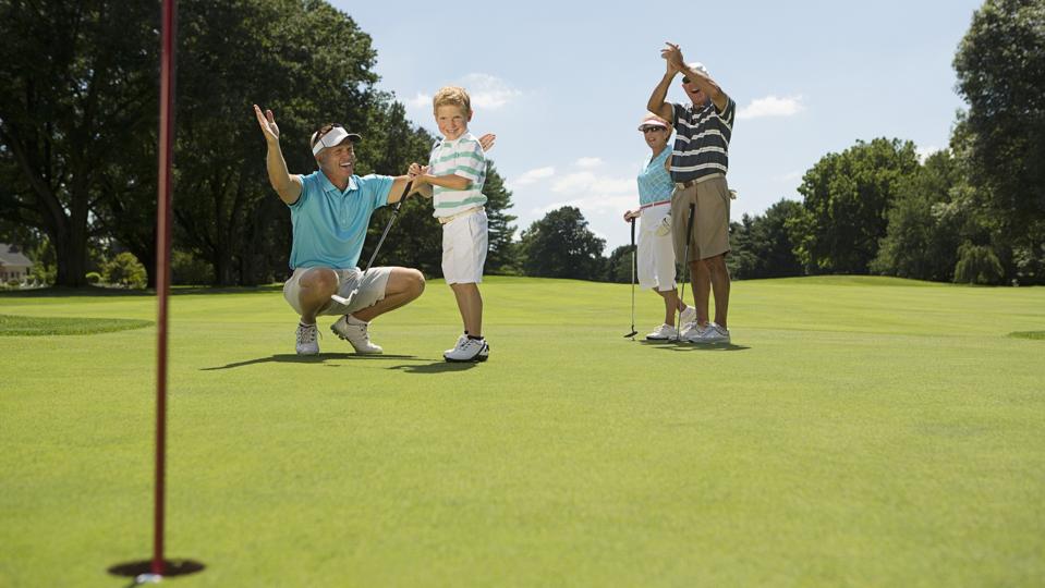 Family golfing at golf course