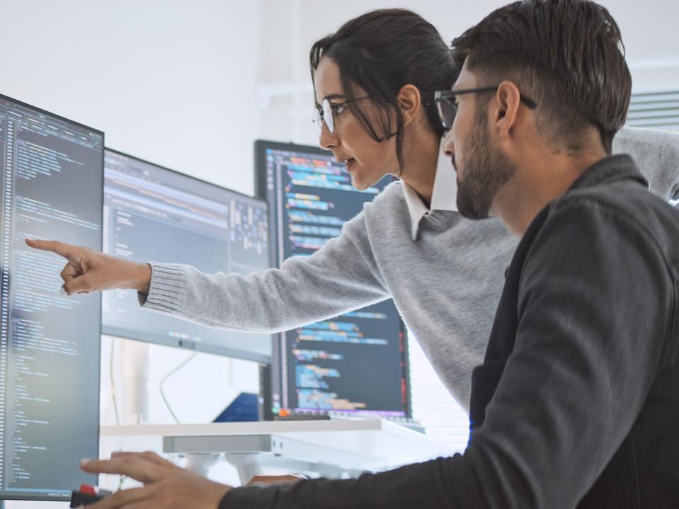 Hispanic Latin American couple, software engineer developer use computer, work on program coding together at home office. Programming language development technology, freelance job concept