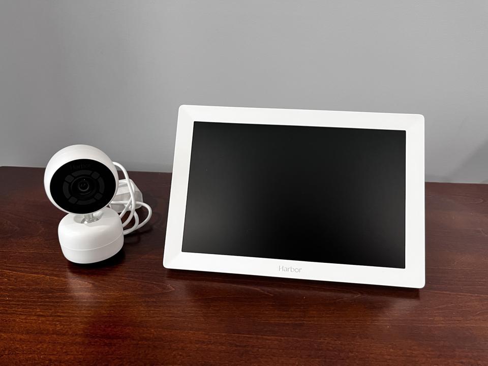 The Harbor baby monitor camera and parent unit sitting on a dresser. 