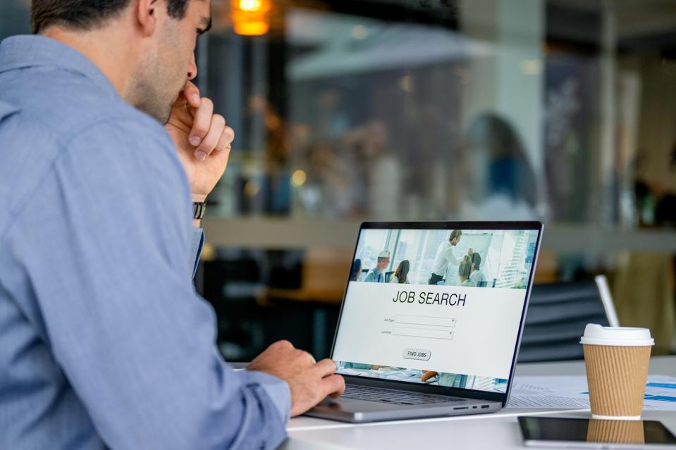 Professional explores job search online, highlighting trends in today’s job market.