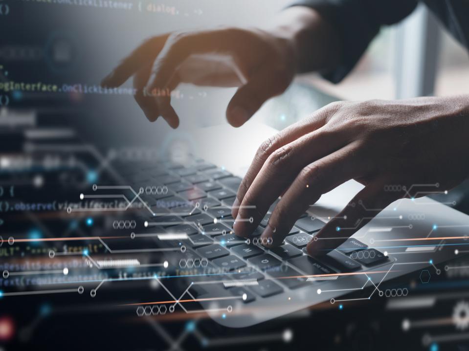 Digital technology, software development concept. Coding programmer working on laptop with circuit board and javascript on virtual screen