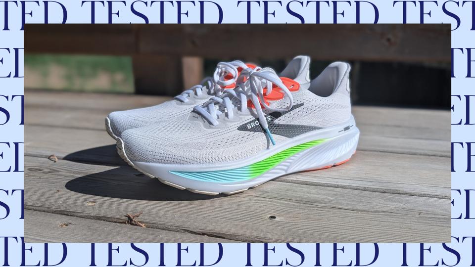 Brooks Ghost 17 in white with green, blue and salmon accents on a sunny porch
