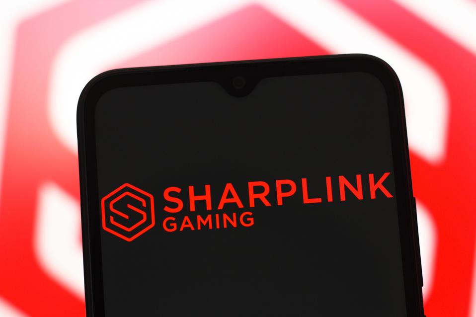 In this photo illustration, the SharpLink Gaming logo is...