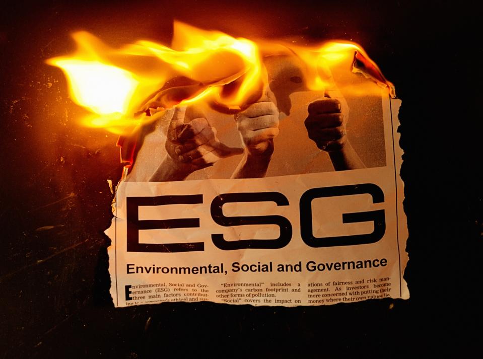 Burning newspaper headline and article about ESG - Environmental, Social and Governance