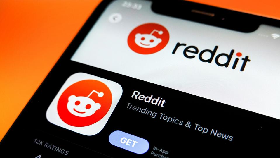 In this photo illustration, the Reddit logo is displayed in...