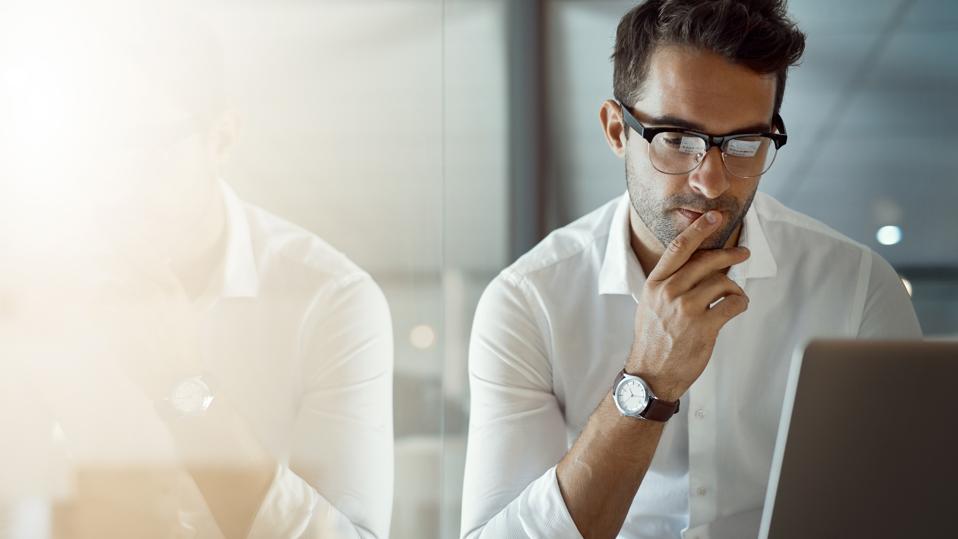 A man looking at his laptop