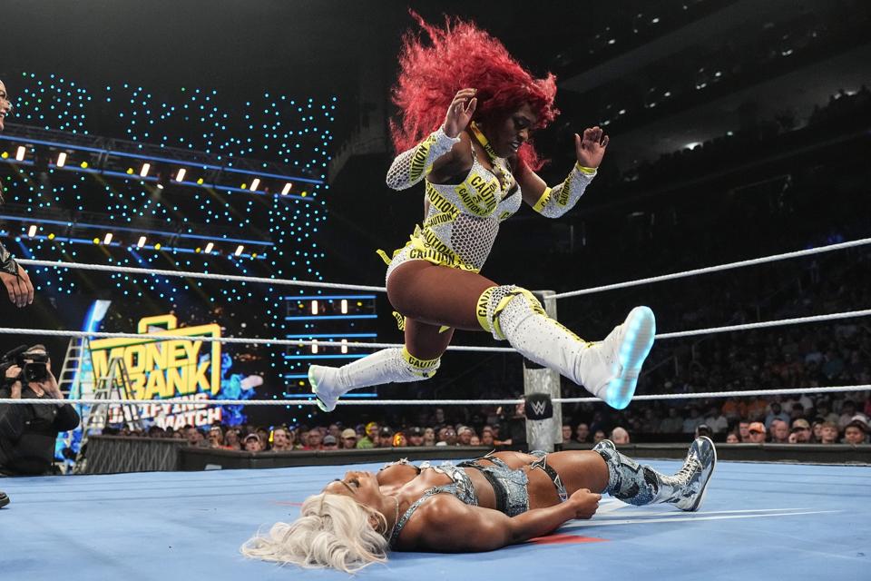 Seth Rollins⁢ celebrates his Money in the Bank victory with the briefcase.