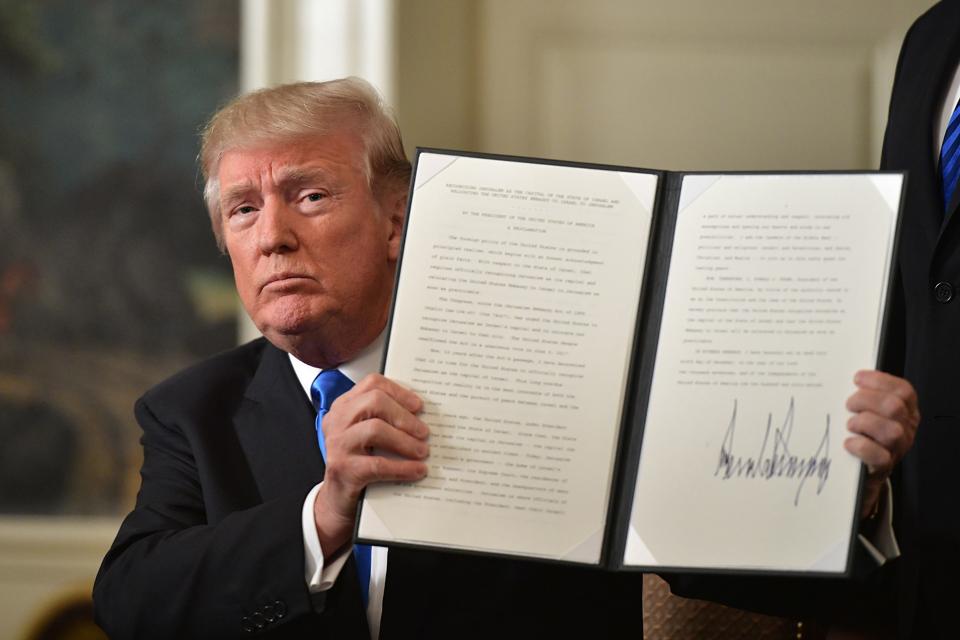 President Trump holds up a signed executive order. He signed an immigration one last week.