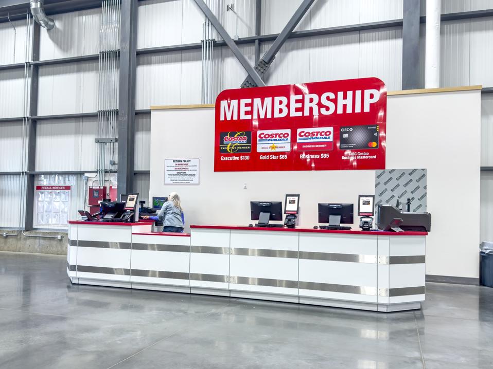 A clean and organized Costco Membership desk, showcasing various membership tiers and the co-branded credit card, ready for new sign-ups.