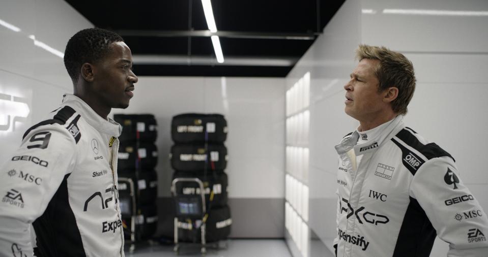 Brad Pitt stands across from Damson Idris in F1 promo image. Both wear Formula One suits
