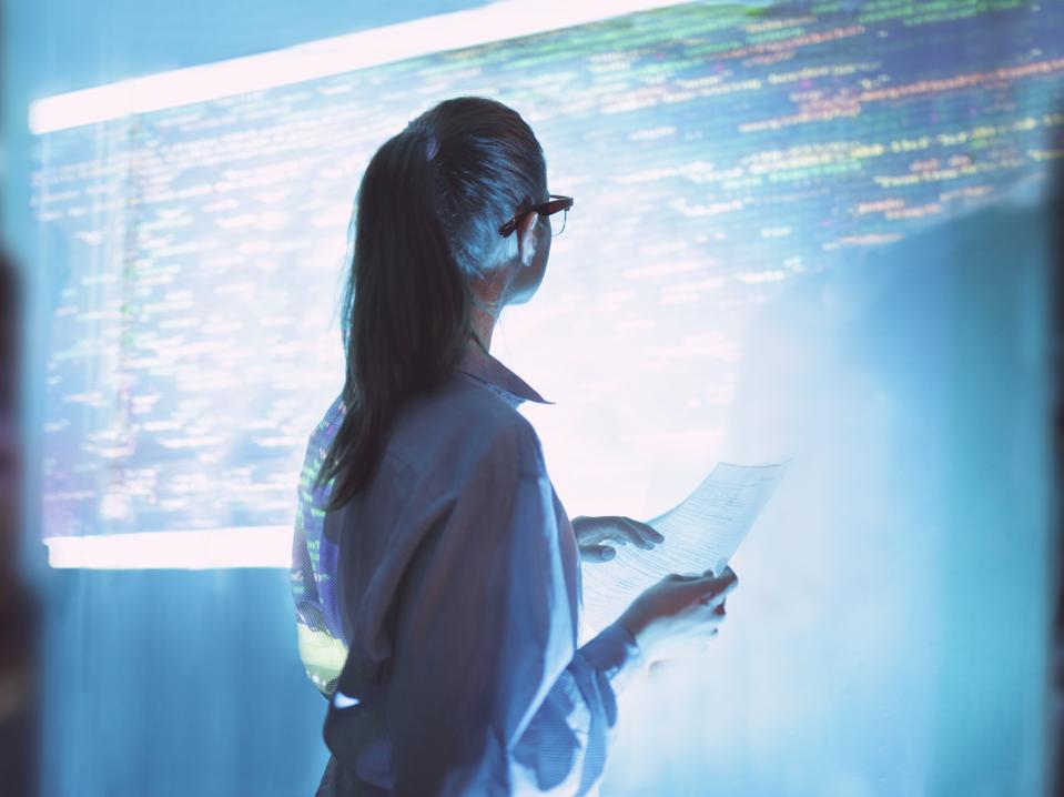 Woman looking at wall with code