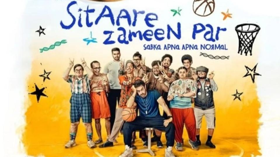 Indian star Aamir Khan poses with the cast of his new Hindi film 'Sitaare Zameen Par' on a poster of the film.