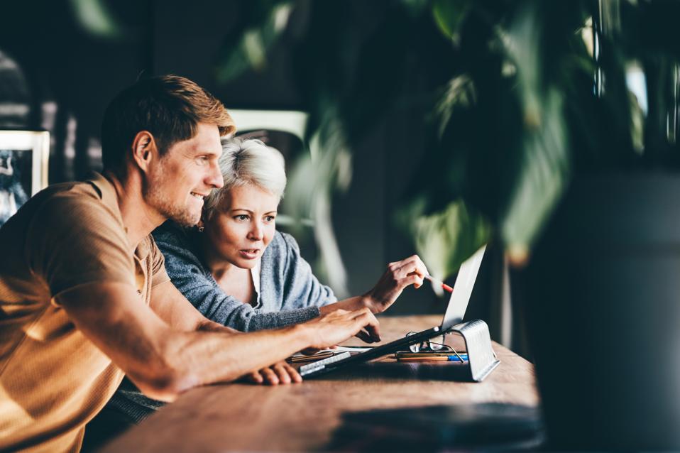 Two business people working together in the office. Businesswoman explains her vision to a colleague.