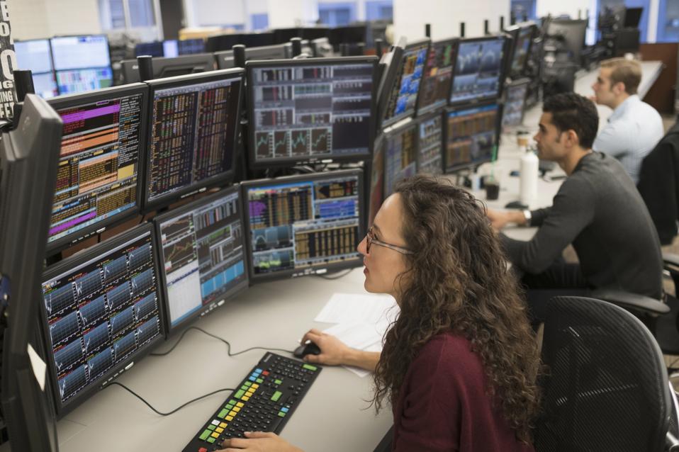 Young traders analyzing computer data