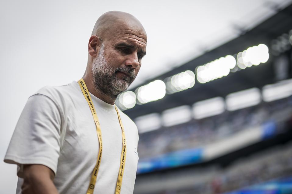 Josep Guardiola, head coach of Manchester City FC, looks on...