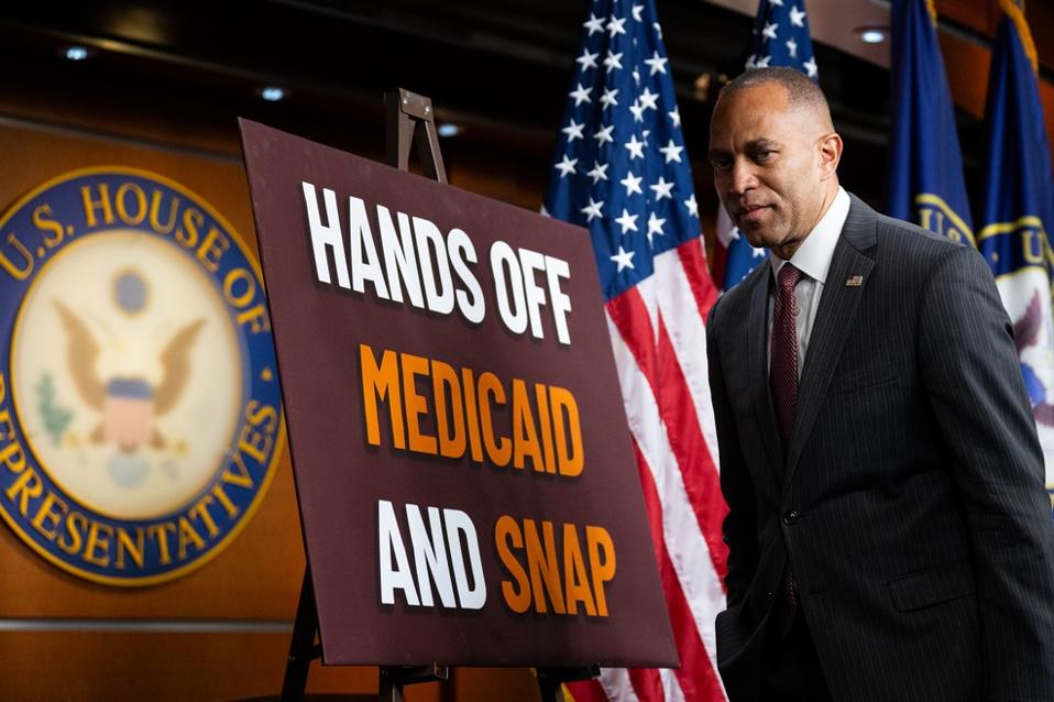 Hands off Medicaid and SNAP poster on stage