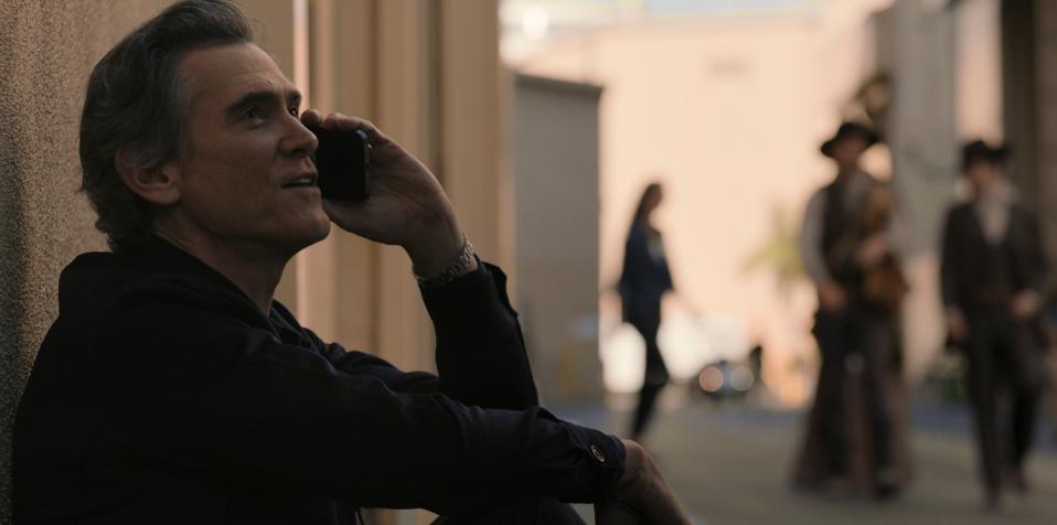 Actor Billy Crudup, shown talking on a phone while sitting down