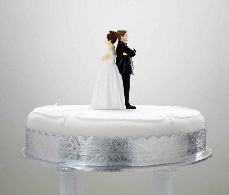Bride and bridegroom cake decoration on top of wedding cake,