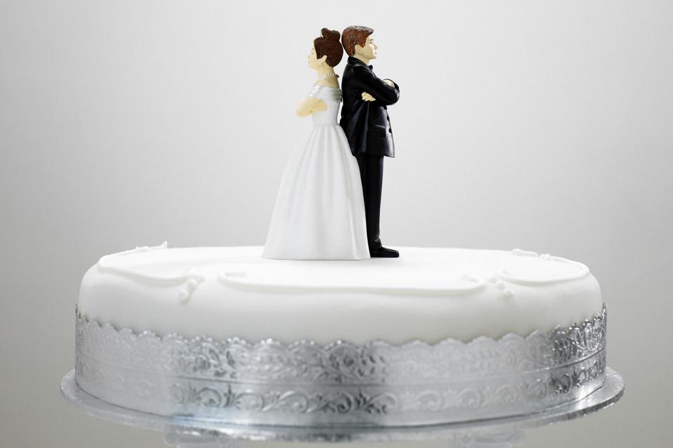 Bride and bridegroom cake decoration on top of wedding cake,