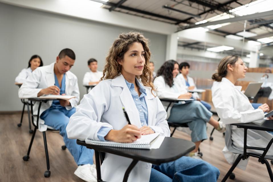 Group of medical students sitting in the classroom listening to a lecture