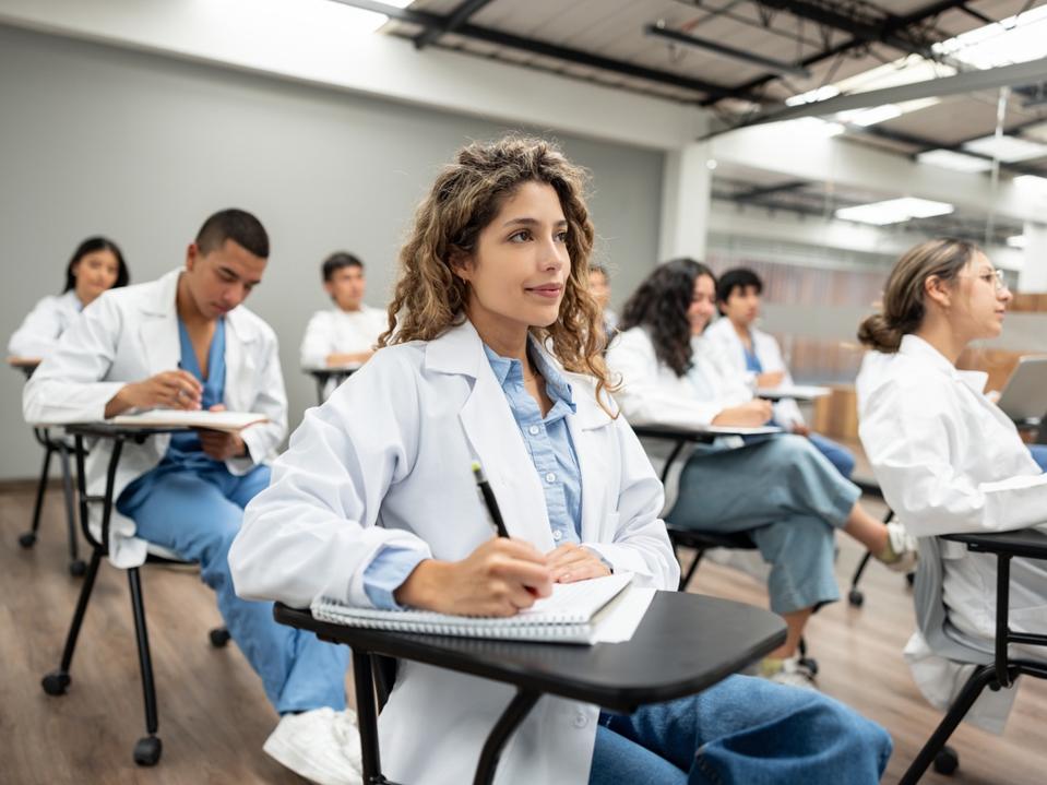 Group of medical students sitting in the classroom listening to a lecture