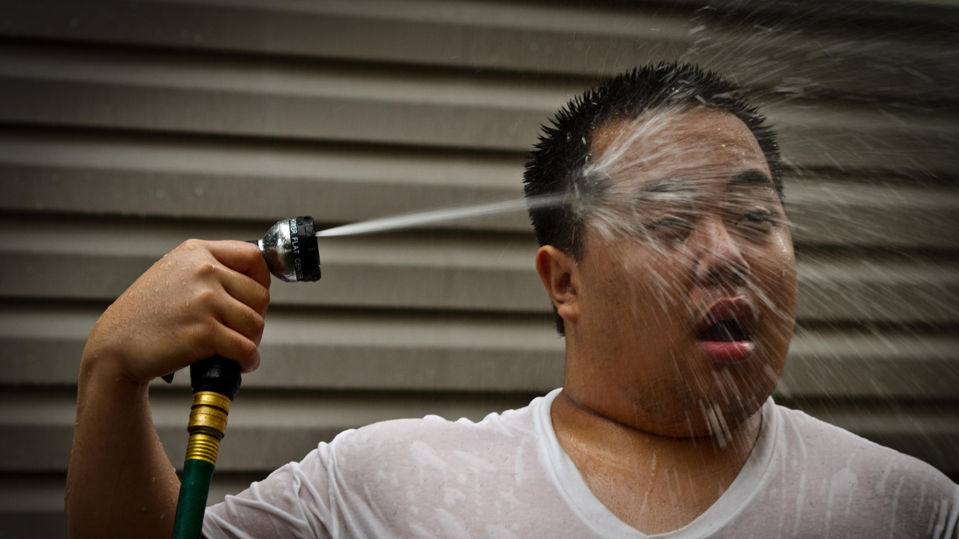 Cooling down with a hose during a heat wave