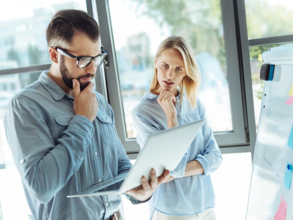 Young colleagues pondering over the problem solution