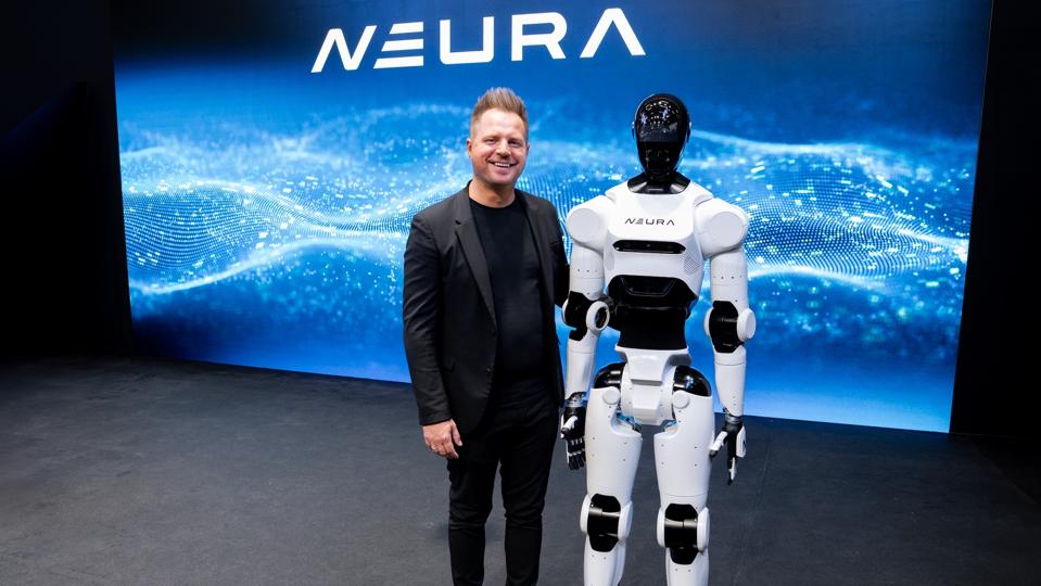 Neura Robotics' CEO David Reger with the third-generation 4NE-1 humanoid robot