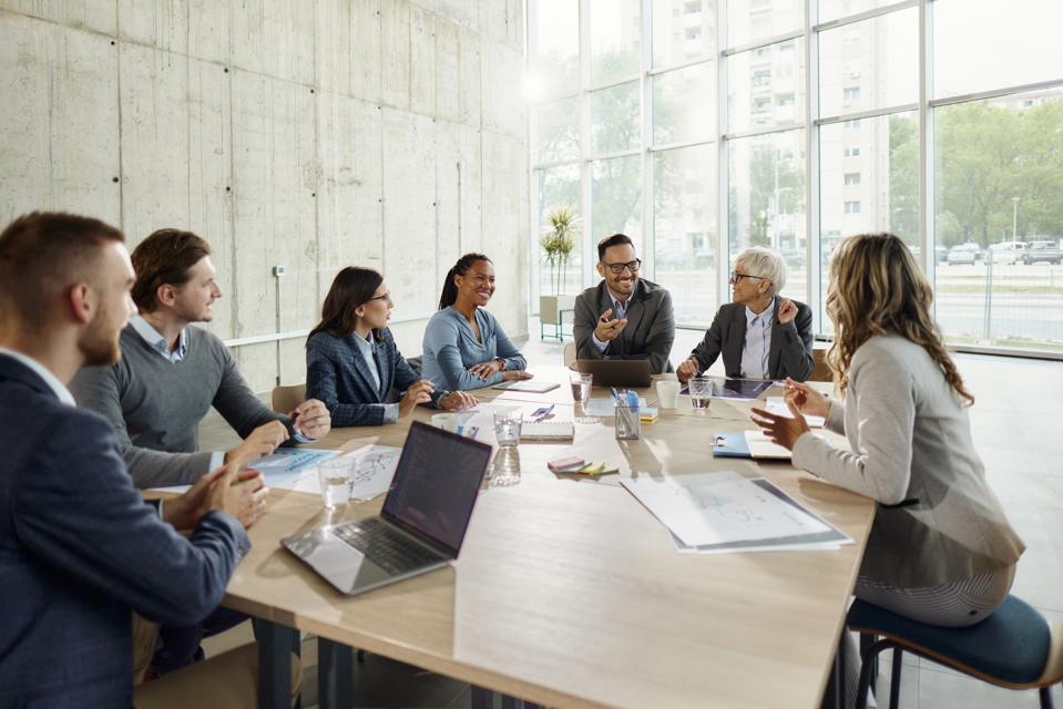Entrepreneurs and business admins meeting in large conference room