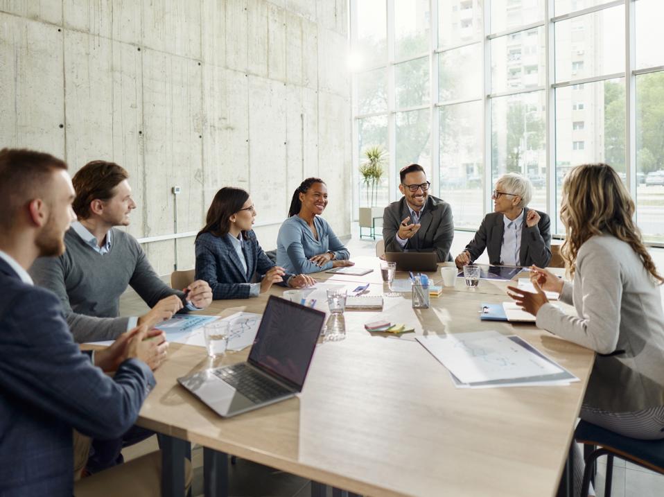 Entrepreneurs and business admins meeting in large conference room