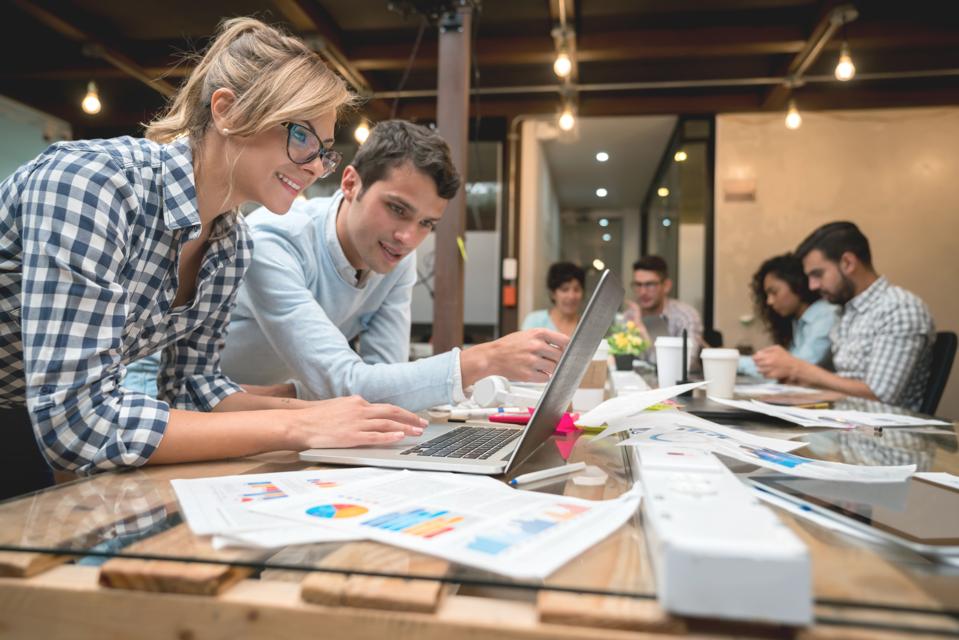 Business team working on e-commerce strategy in an open workspace setting