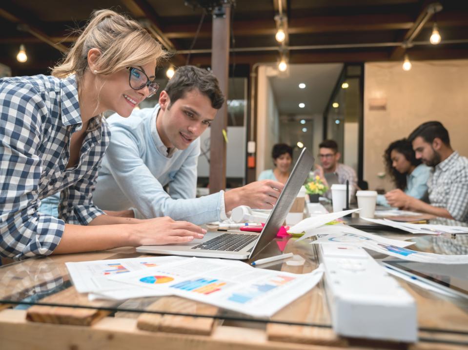 Business team working on e-commerce strategy in an open workspace setting