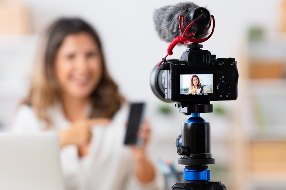 Woman recording a video tutorial from home
