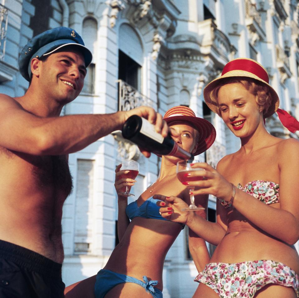 Beach revelers in Cannes drinking roes wine