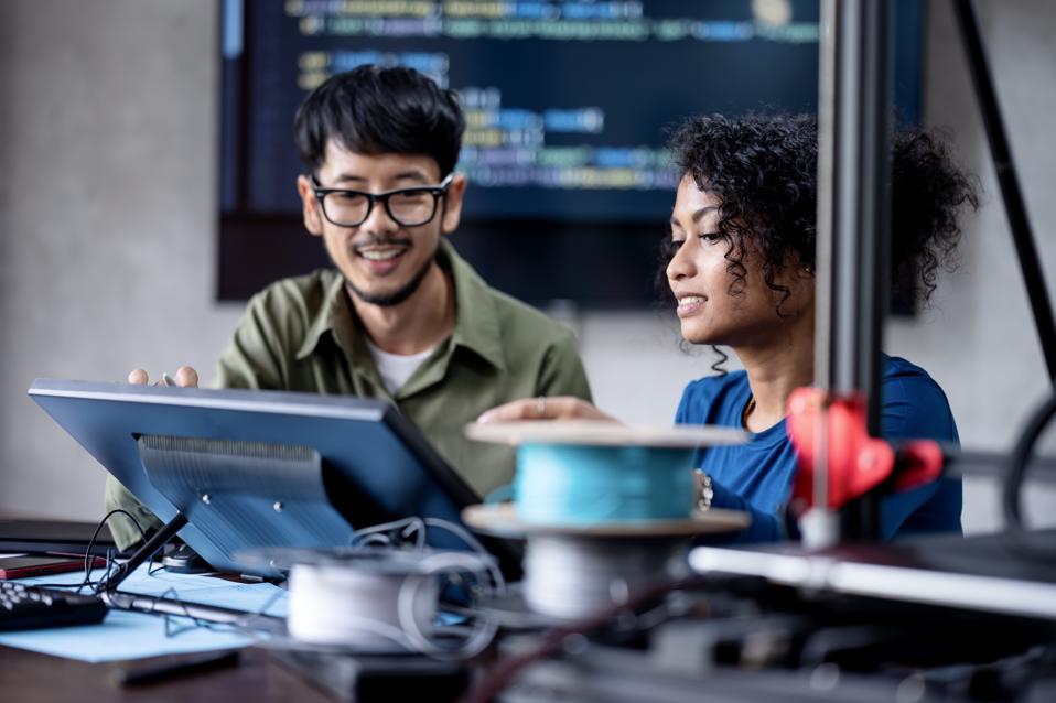 Build a Software Development Team to Running Your Business Growth.  Software Engineers on the project discuss a database design workflow and technical issues in a tech business office.
