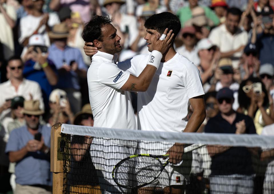 Victor Carlos Alcaraz and Fabio Fognini embrace after a five-set battle at Wimbledon.