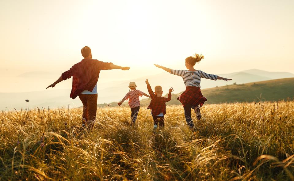 family wellness: mother, father, children son and daughter on sunset, sunlight