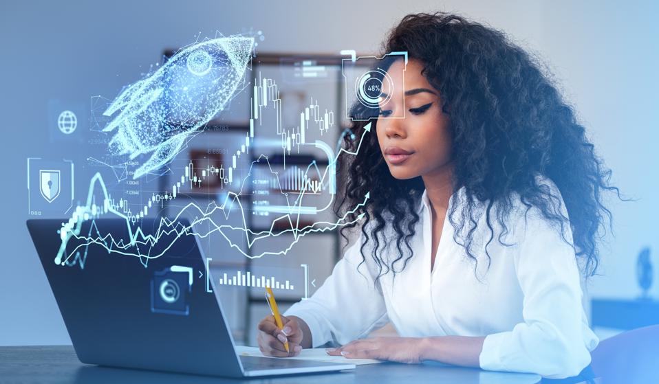 African businesswoman working with laptop, forex hologram with rocket